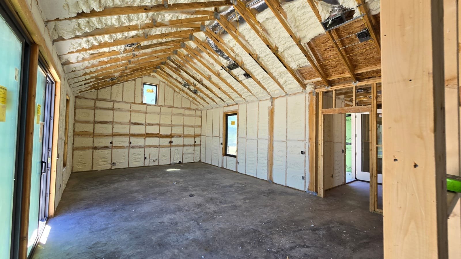 Spray foam insulation being applied to wall cavities — Desert Spray Foaming