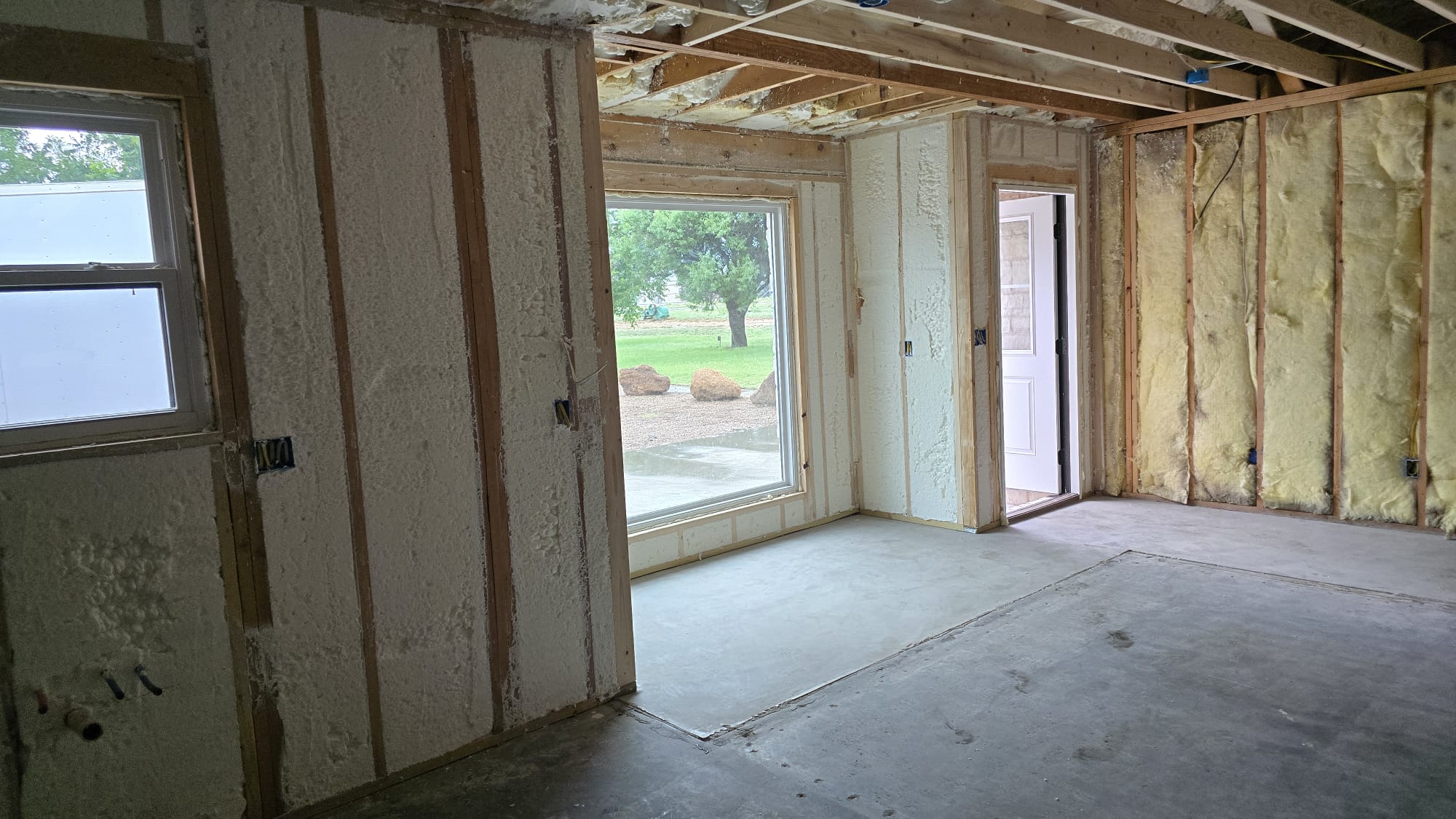Spray foam insulation being applied to wall cavities — Desert Spray Foaming