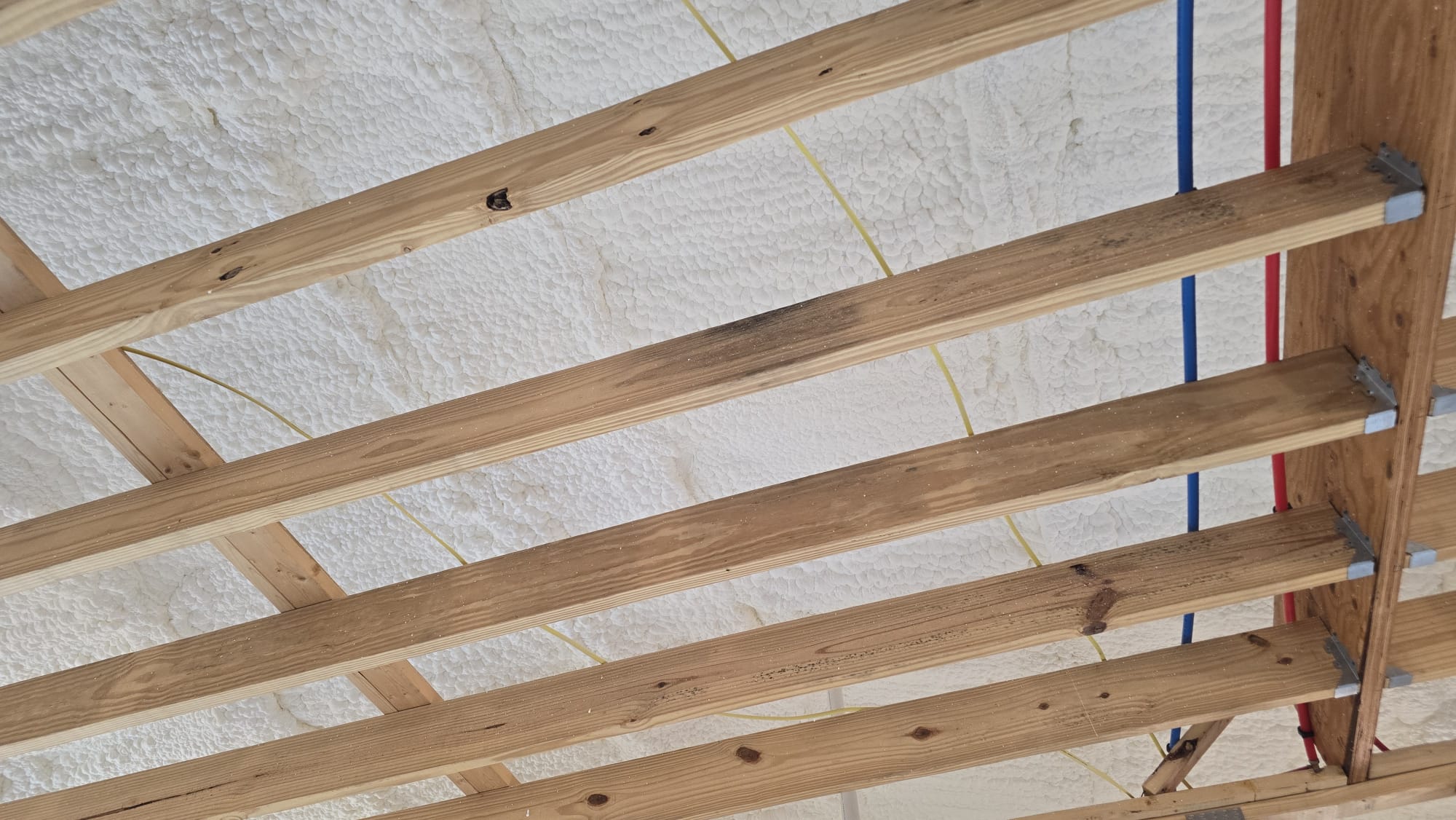 Spray foam insulation being applied to wall cavities — Desert Spray Foaming